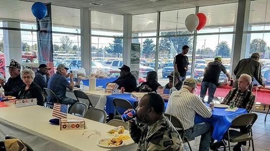 People eating food at an event and drinking pepsi